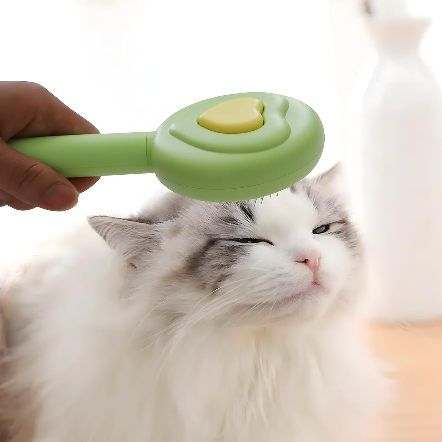 Leevar self-cleaning slicker brush in use on a long-haired cat